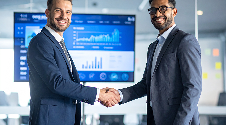 Firefly_A business executive shaking hands with a web developer in a modern office, a large s 820067 Firefly_A business executive shaking hands with a web developer in a modern office, a large s 820067