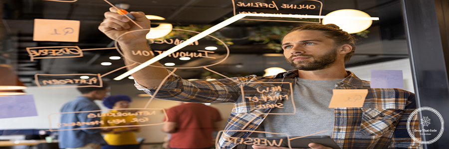 Caucasian casual businessman making notes on glass wall in office, brainstorming. Casual office, brainstorm, business and creative work, unaltered. Caucasian casual businessman making notes on glass wall in office, brainstorming. Casual office, brainstorm, business and creative work, unaltered.