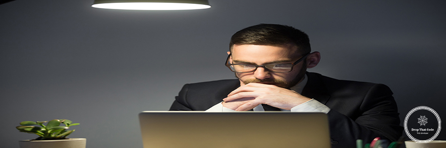Concerned male thinking about company problem solution Concerned worker looking at laptop screen, thinking about problem solution, risks, company success strategies, person reading financial report. Concept of hardworking, concentration, making decision