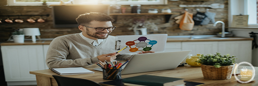 Happy entrepreneur having online business meeting from home. Happy businessman using computer and analyzing charts during conference call at home.