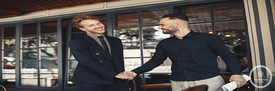 Portrait of cheerful young manager handshake with new employee. Men shake hands. Enclosure of a business agreement. Understanding between business partners.