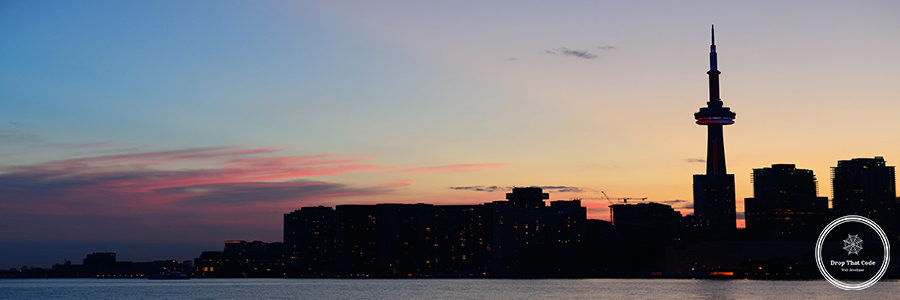 Toronto silhouette Toronto city skyline silhouette at sunset over lake with urban skyscrapers.